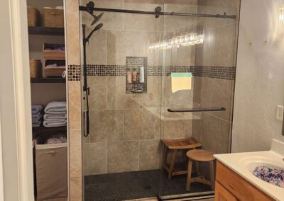 New shower doors in spacious shower with stools